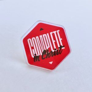 Red octagonal pin reading “Couple in Christ” on a white background
