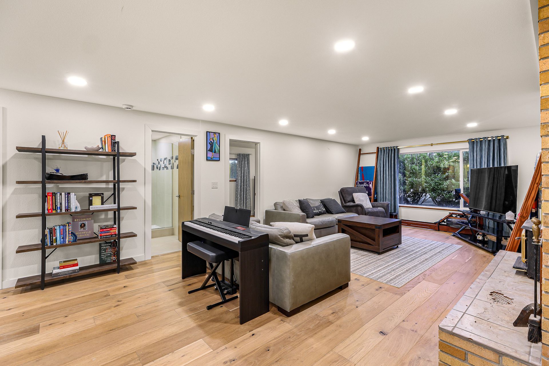 Open living area with music corner and additional seating.
