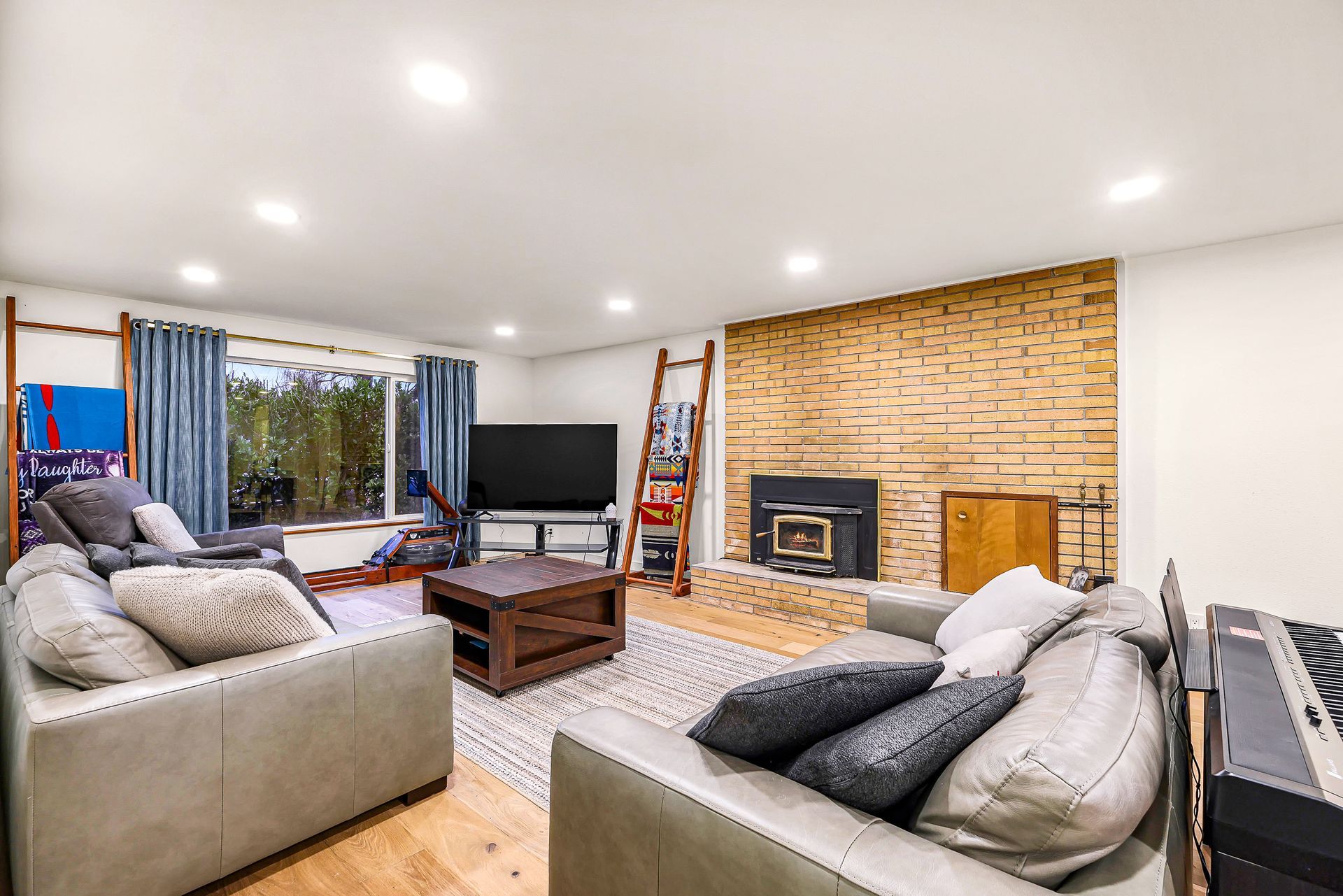 Living room at 2155 Postal Avenue with fireplace and windows.

