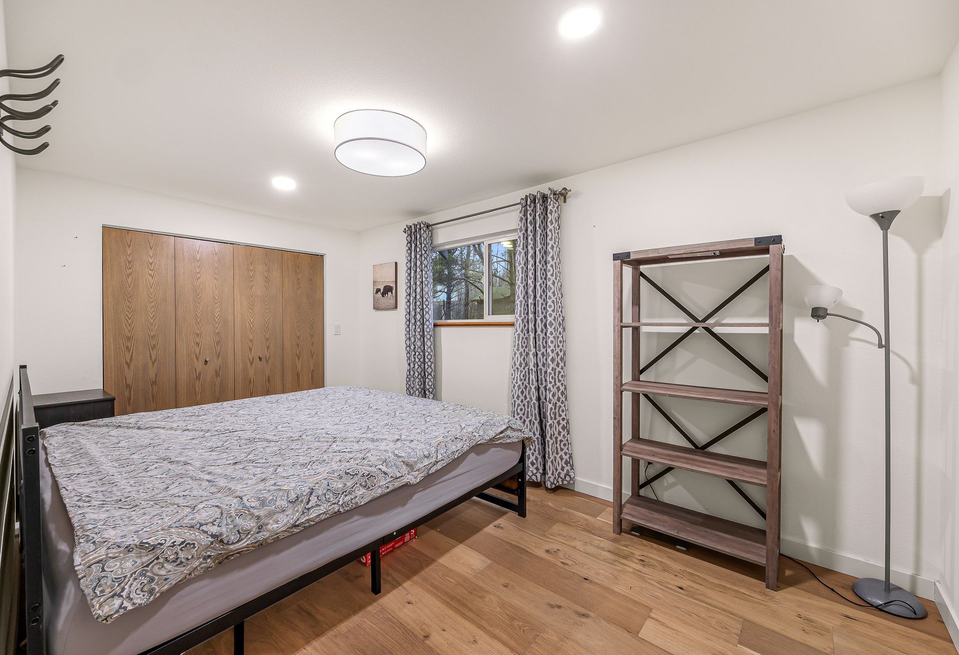 Cozy bedroom with soft lighting and functional design.
