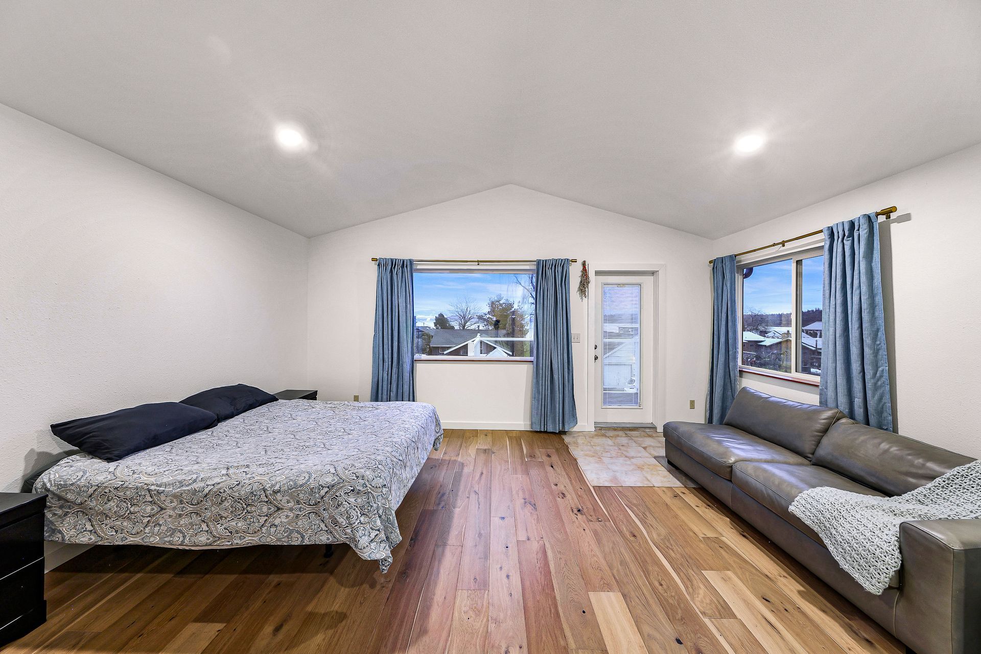 Master bedroom with vaulted ceilings and private balcony.
