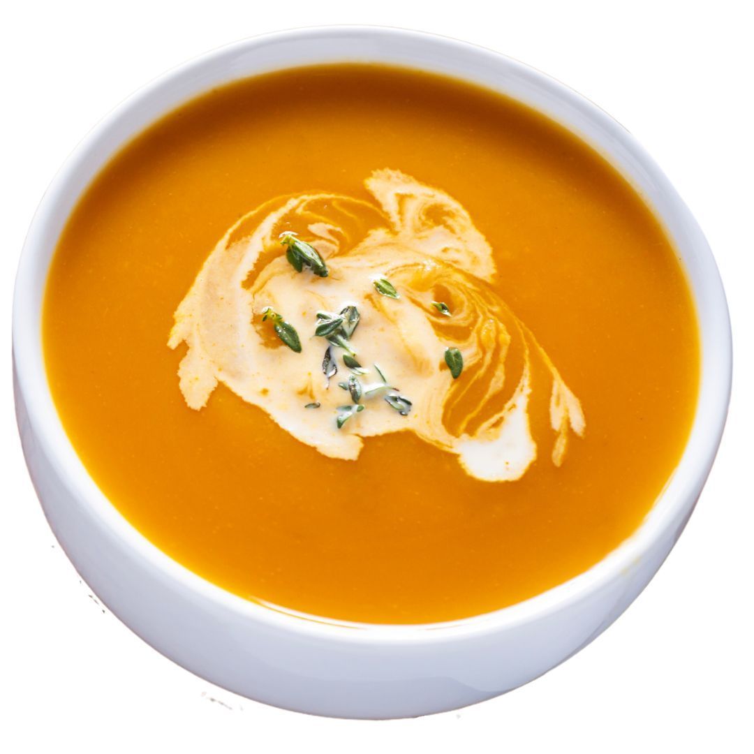 A bowl of soup with whipped cream on top