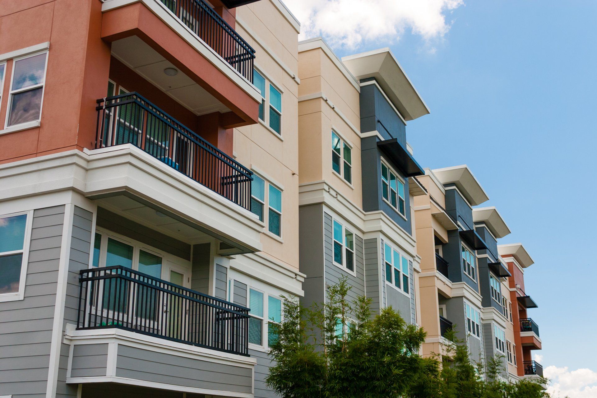A row of apartment buildings with balconies on a sunny day