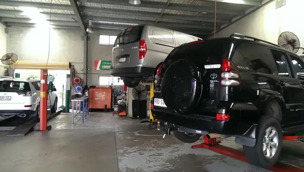 A Black SUV's Sitting On A Lift In A Garage — Headland Auto Servicing & Air Conditioning In Alexandra Headland, QLD