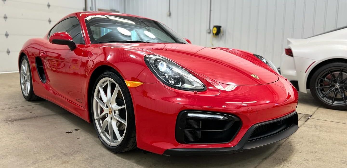 red car parked inside the detailing shop