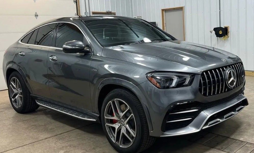 Gray Mercedes SUV parked indoors in a garage, angled front-left view.