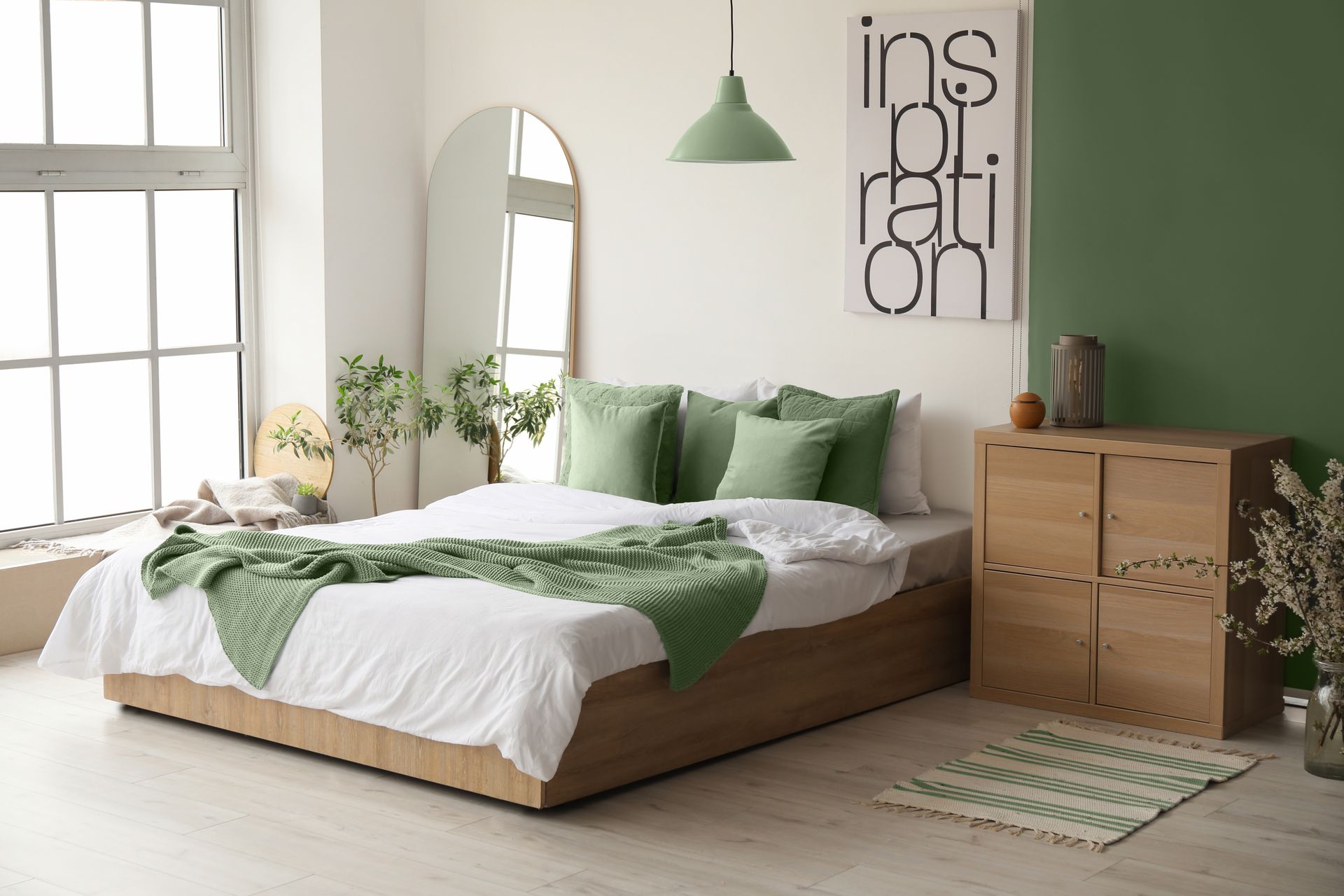 A bedroom with a mid-century modern design style and green color palette