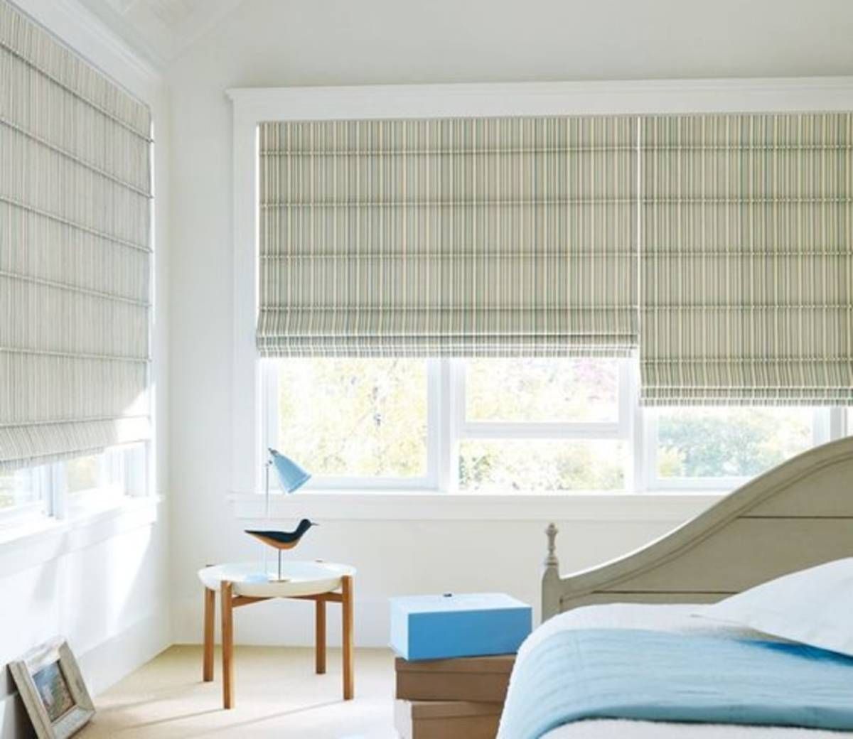 Striped Roman shades in neutral tones are a versatile curtain alternative for layered window treatme