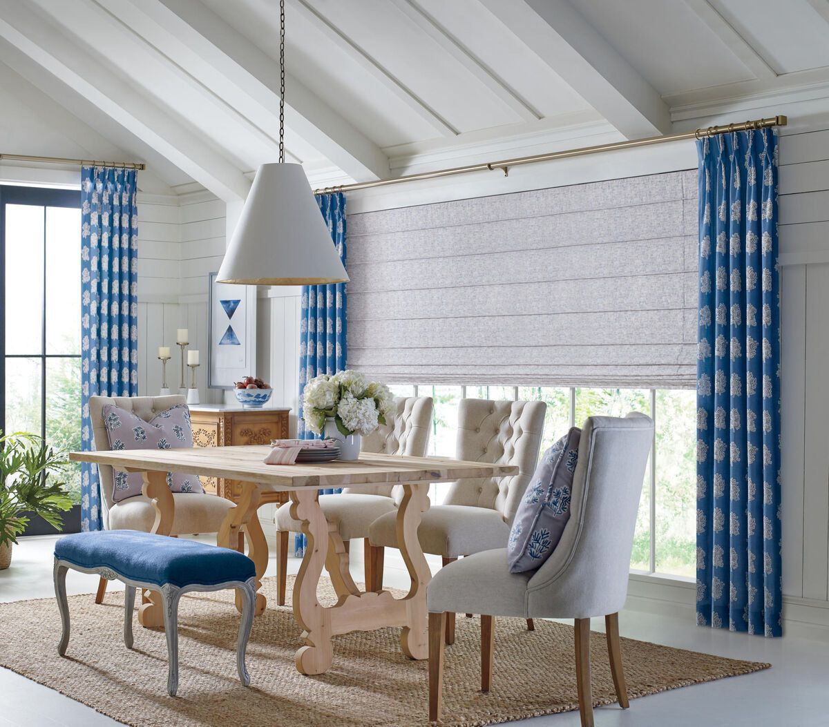 Hunter Douglas Roman Shades in a cozy farmhouse dining room.