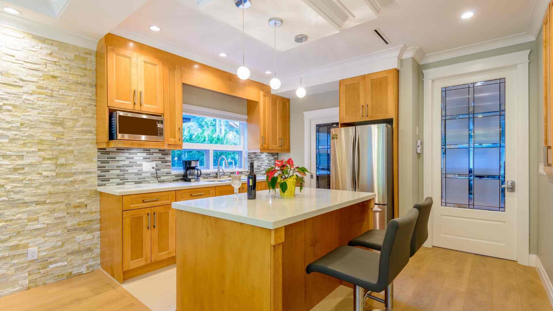A luxury kitchen with wood and stone elements and a large window near the sink at The Blind Guy Kalispell near Flathead Valley, Montana (MT)