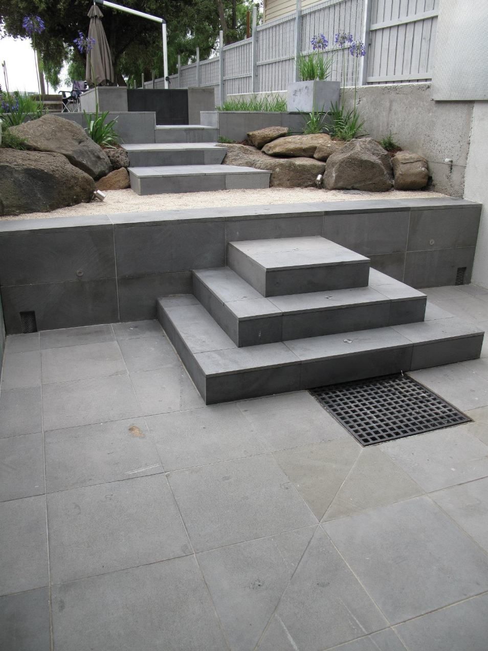 A Set Of Stairs Leading Up To A Patio With A Fence In The Background — Leemark Design Services In Parramatta Park, QLD
