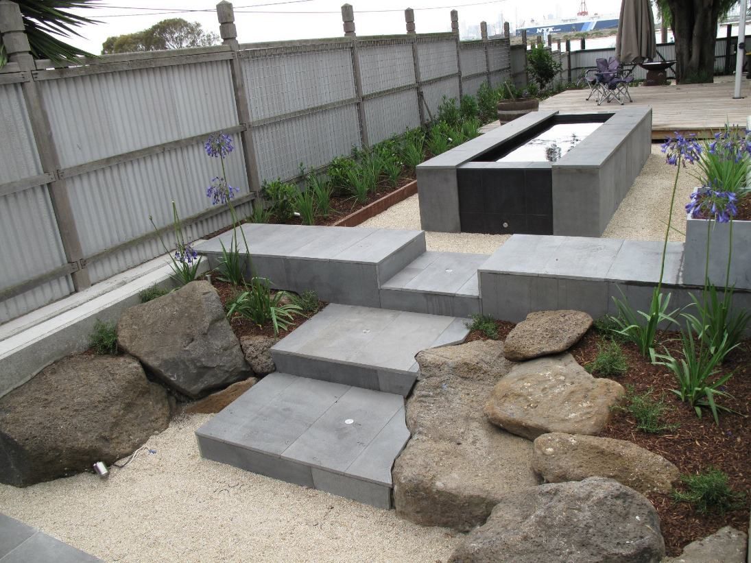 A Garden With Stairs And Rocks And A Fence In The Background — Leemark Design Services In Parramatta Park, QLD
