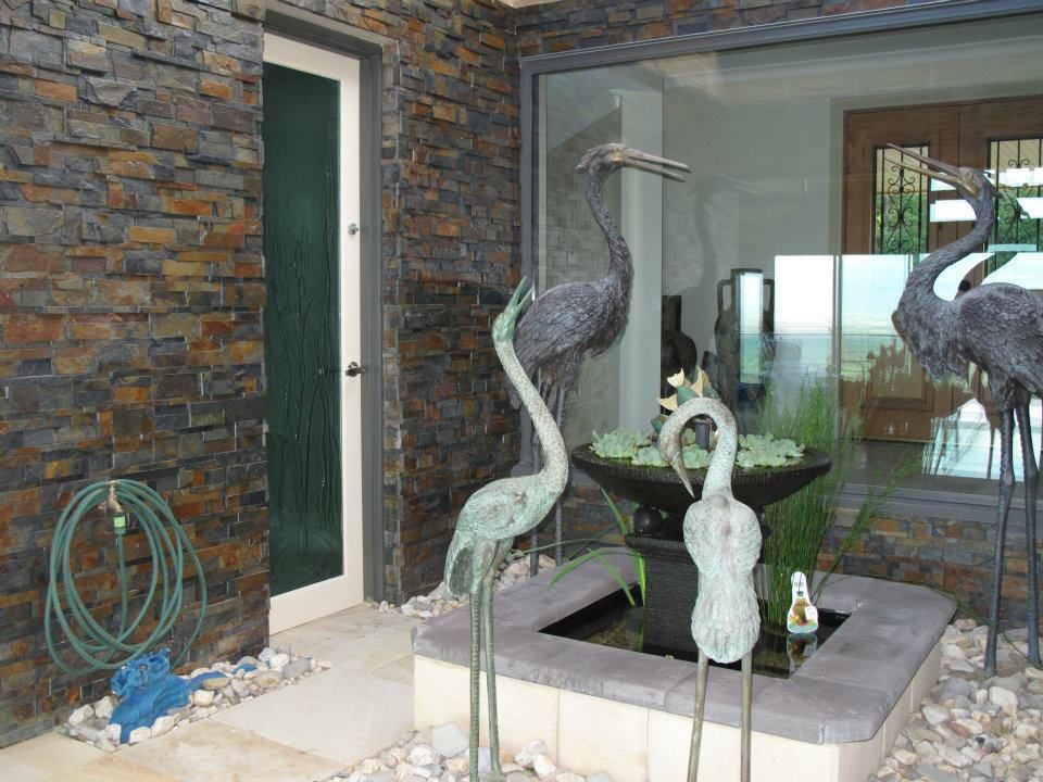 A Fountain With Three Statues Of Birds In Front Of A Door — Leemark Design Services In Parramatta Park, QLD
