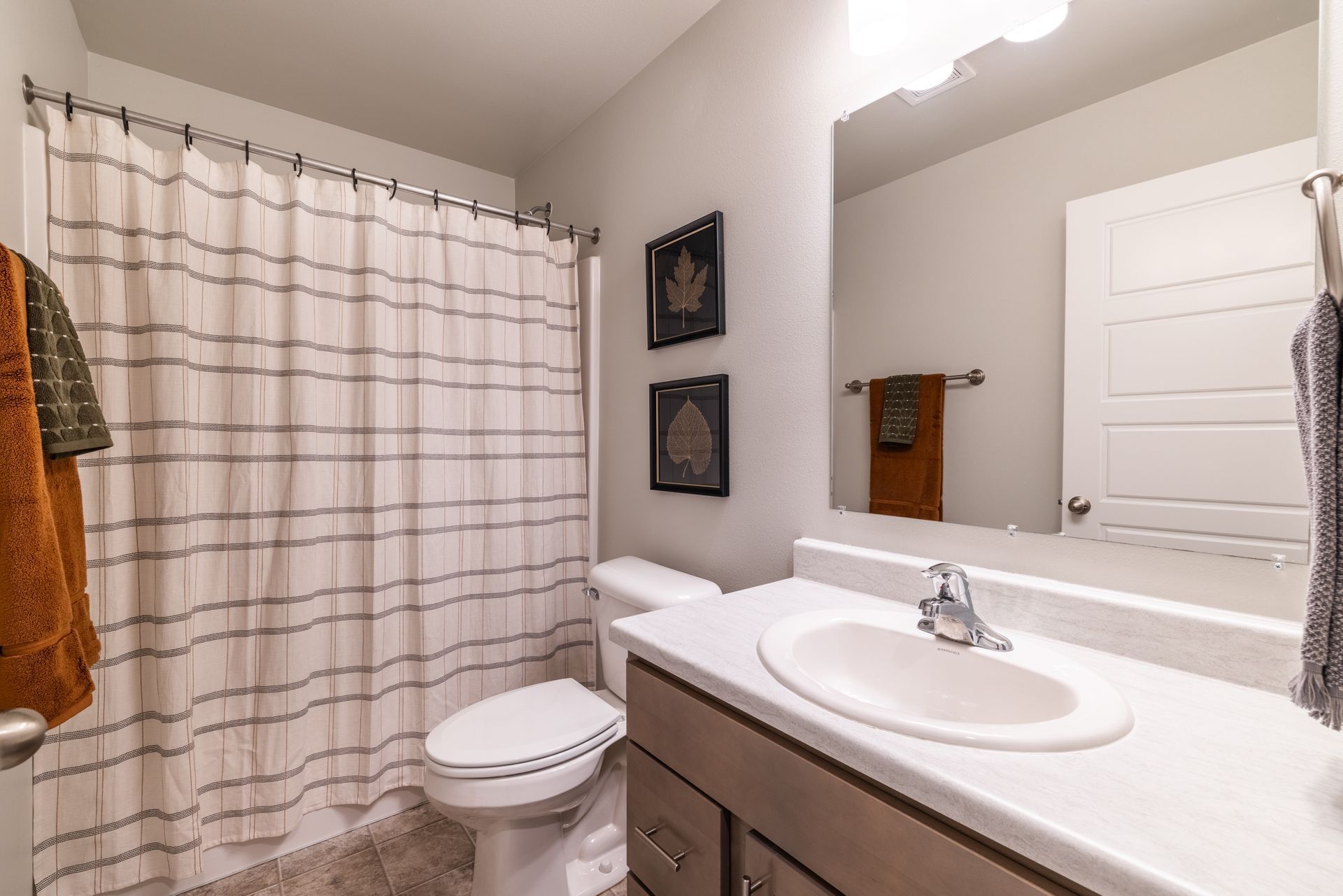 Bathroom with toilet, shower, and sink.