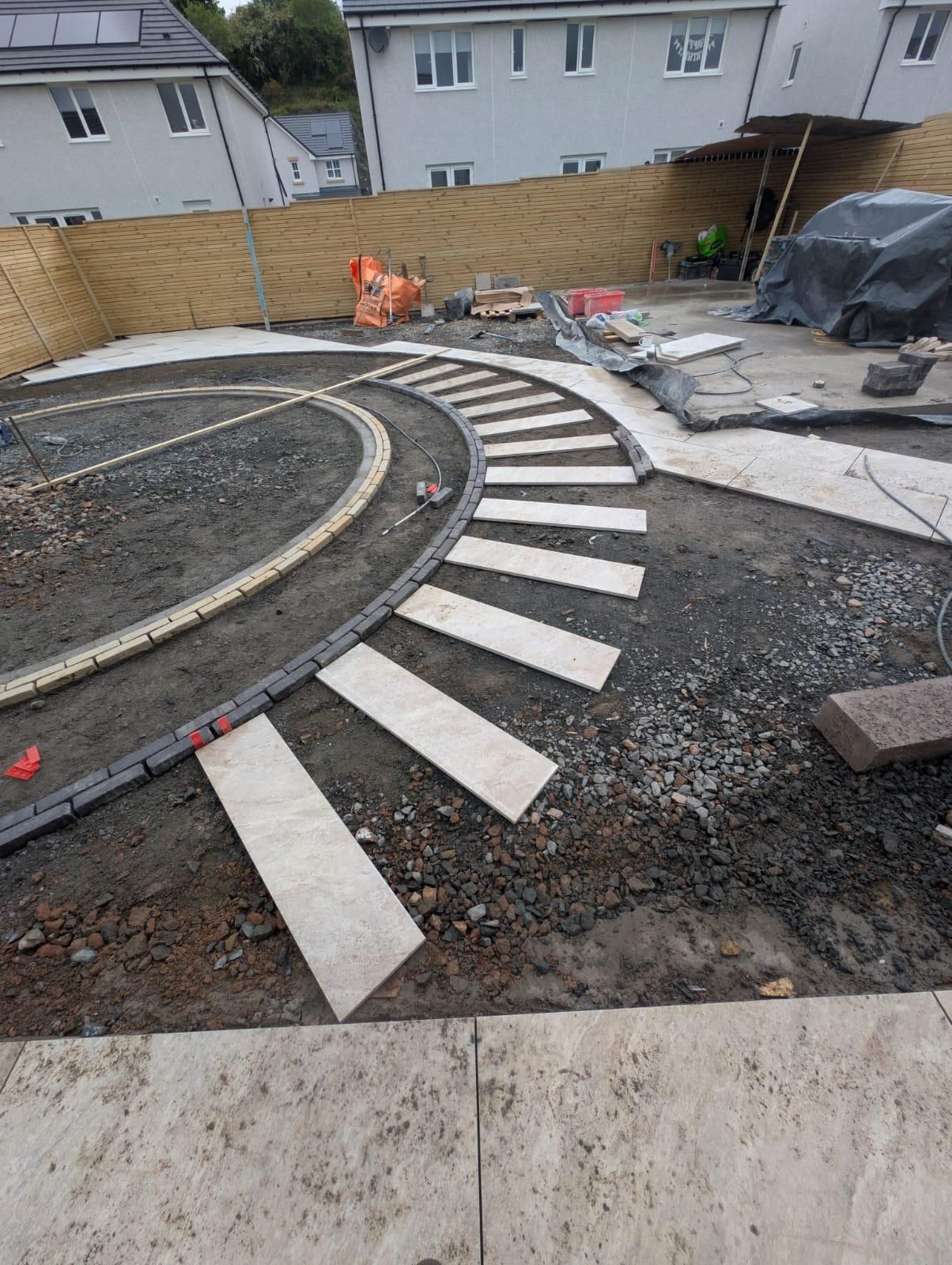 Circular garden and curved stepping-stone pathway being constructed in Croy