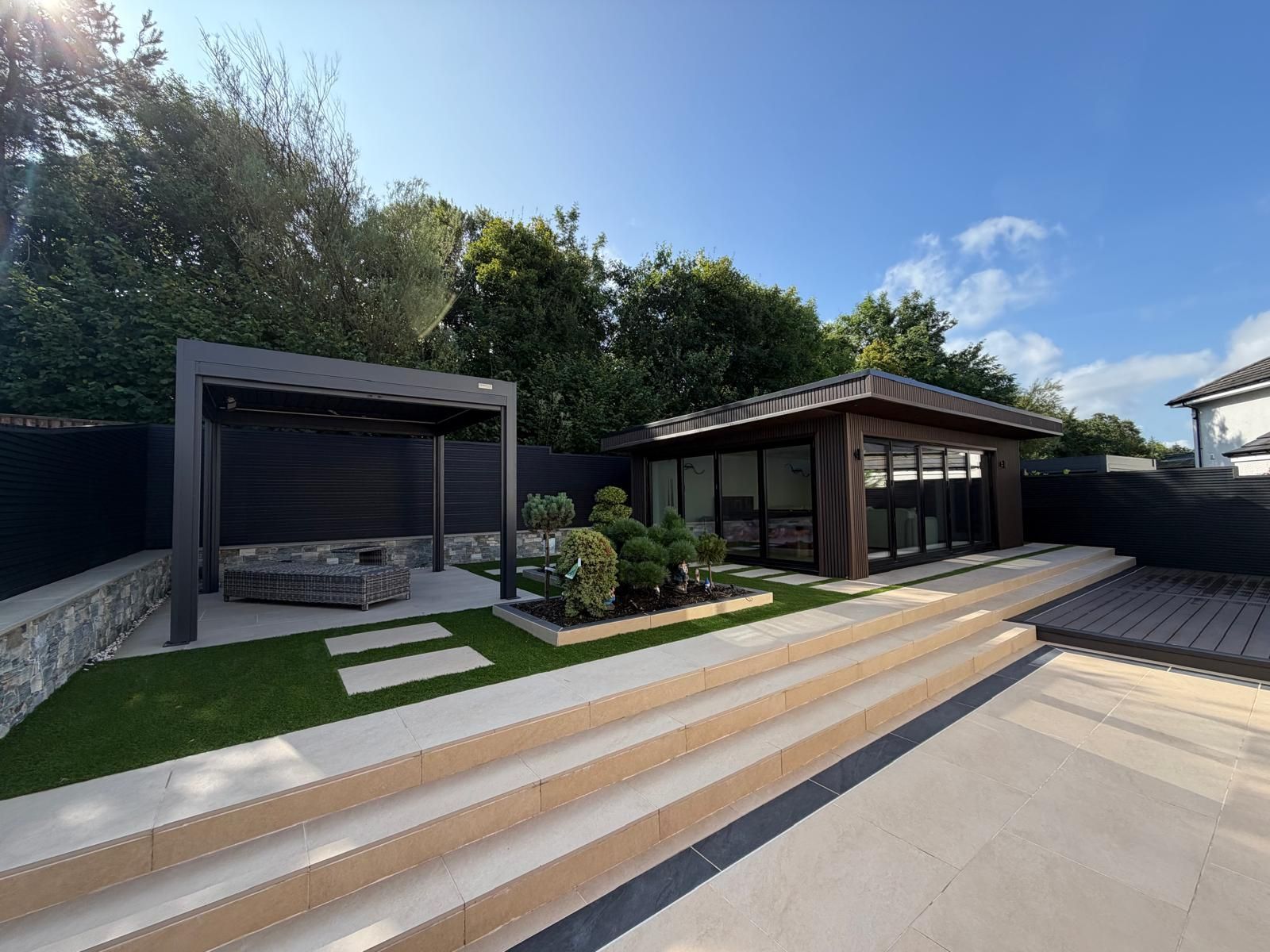 Completed contemporary garden with porcelain terraces, structured planting, pergola and outdoor living area