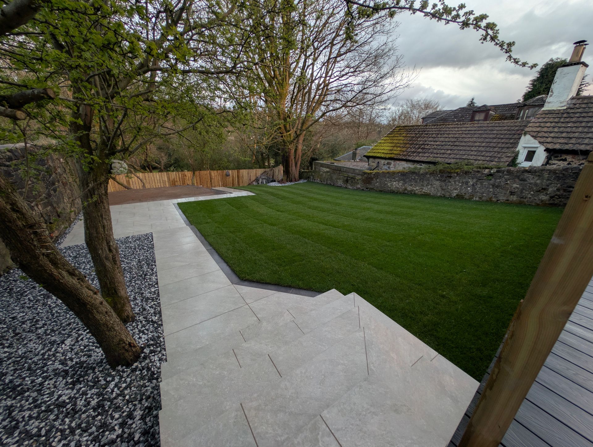 Structural garden transformation in Glasgow showing poor ground conditions before work and a completed hard landscaping build with lawn, patio and garden levels.