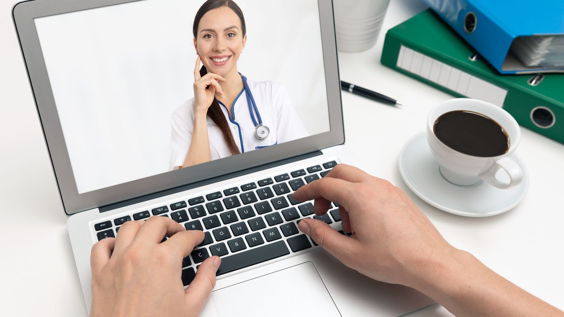 A woman watching a doctor's video on her laptop.