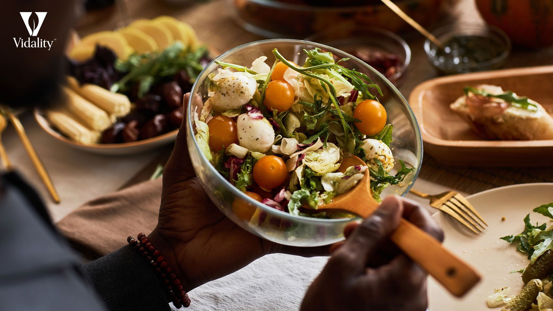 A person holding a bowl of food with a salad, showcasing a healthy meal option.