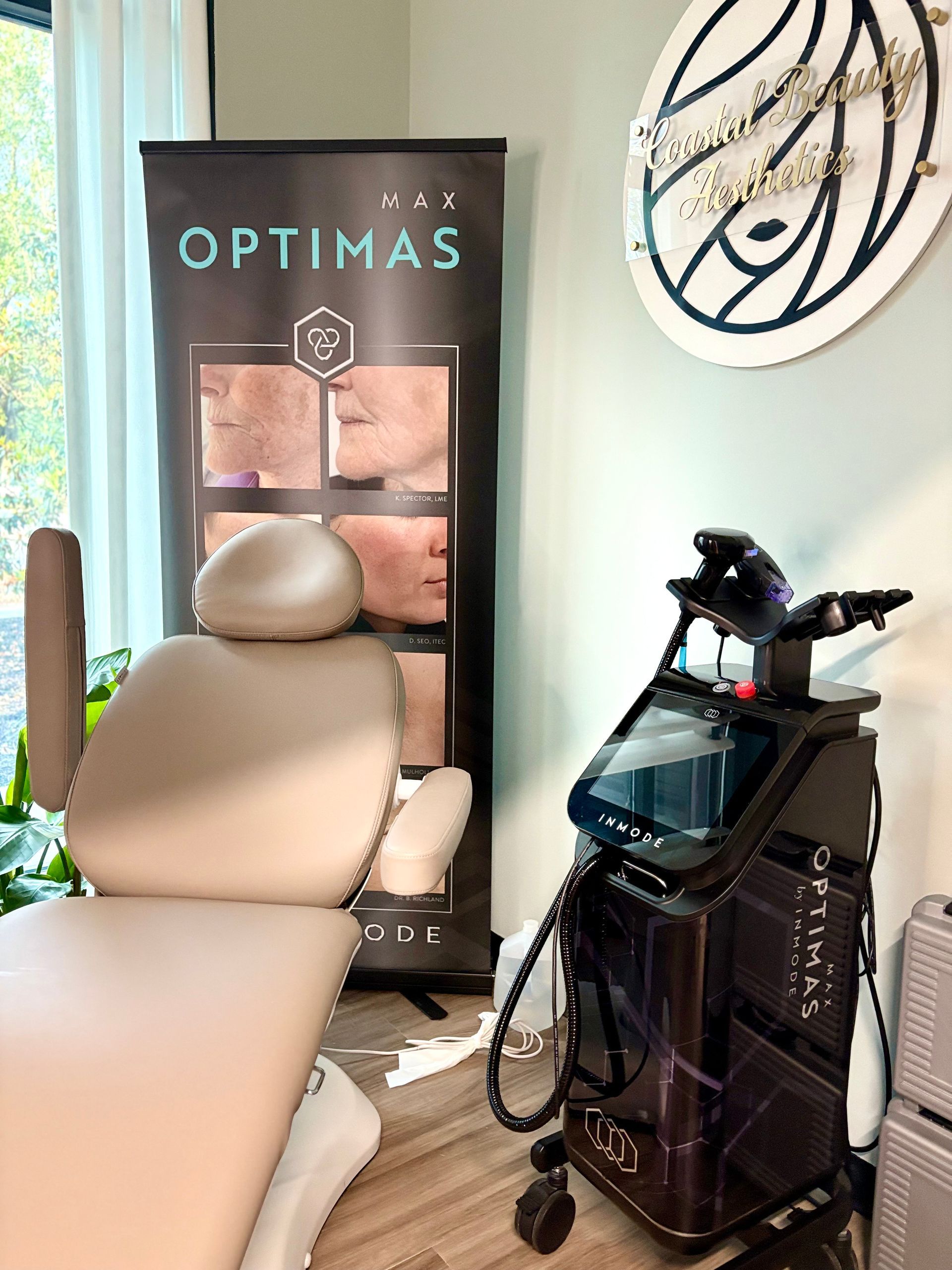 Clinic treatment chair beside an OPTIMAS sign and spa equipment in a bright room