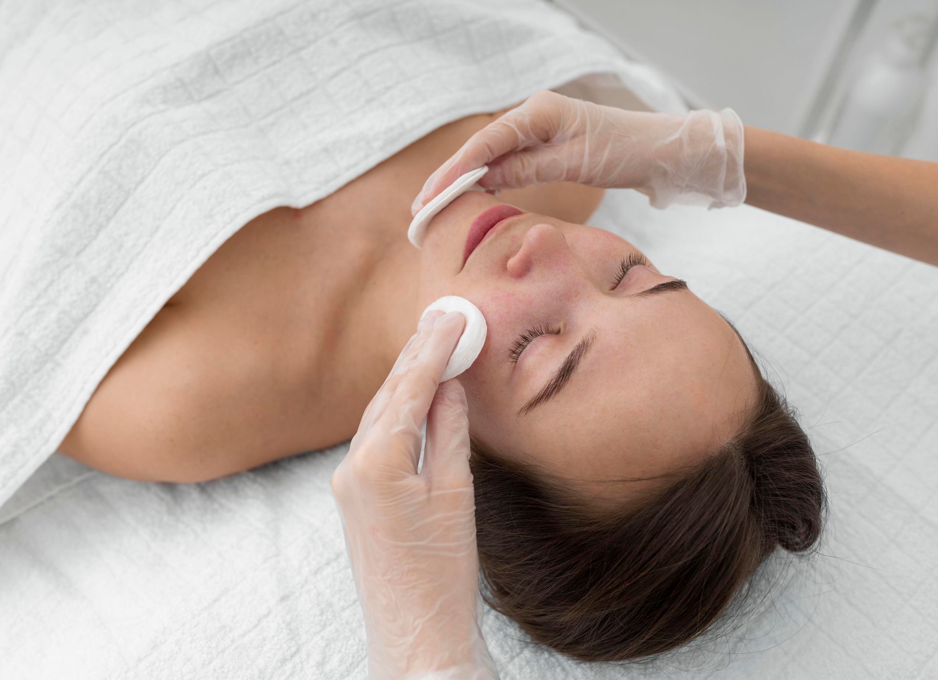A woman is getting a facial treatment at a spa.
