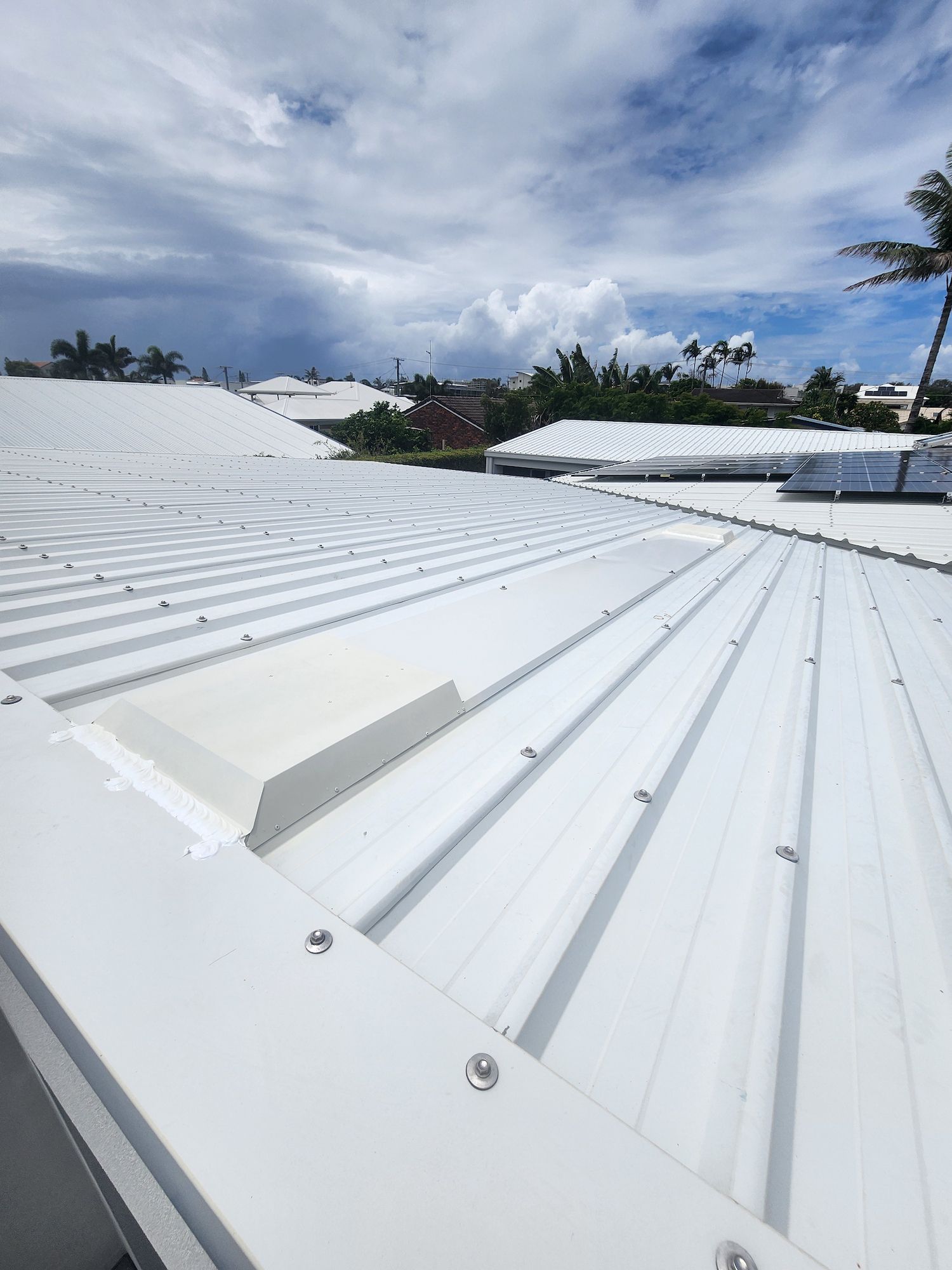 Two Metal Domes on Top of a Roof With a Blue Sky in the Background — Vent Wise in Twin Waters, QLD