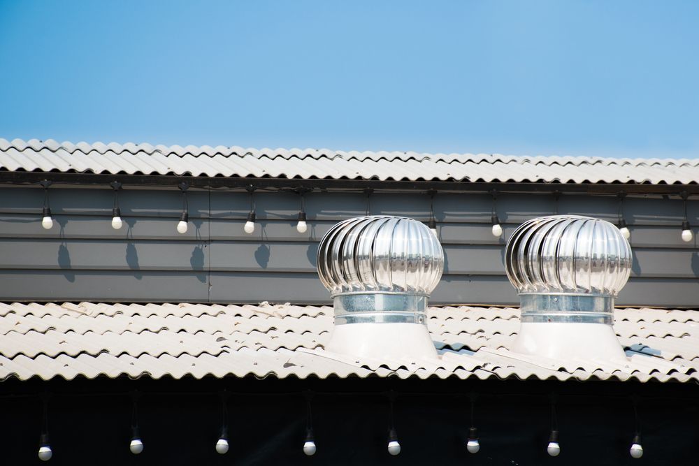A Roof With a Fan on Top of It and a Blue Sky in the Background — Vent Wise in Queanbeyan, NSW