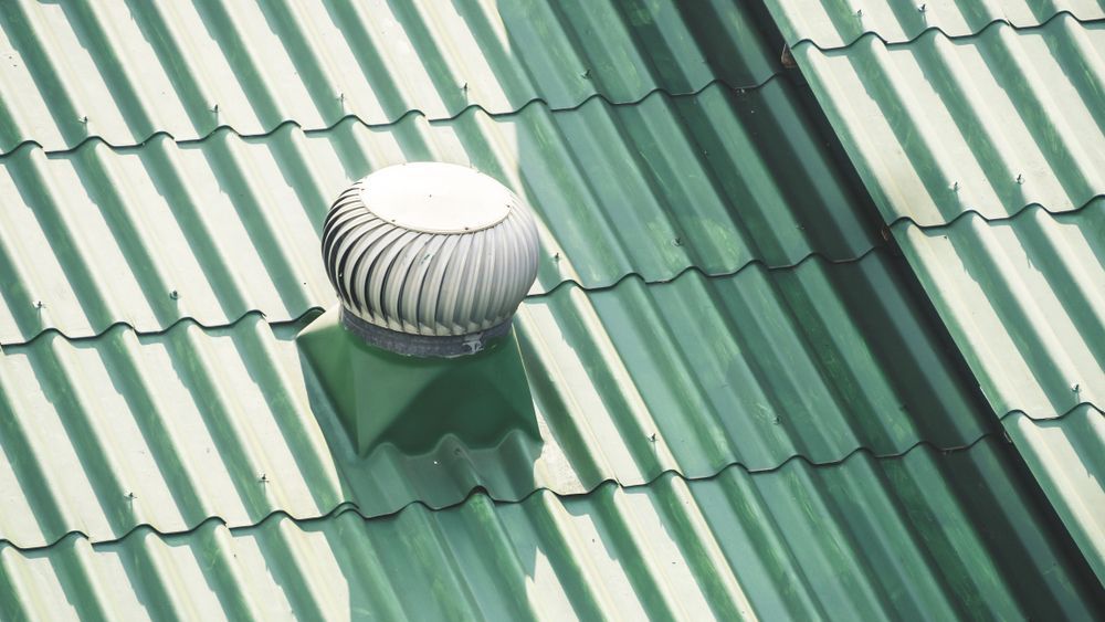 A Green Roof With a White Fan on Top of It — Vent Wise in Twin Waters, QLD