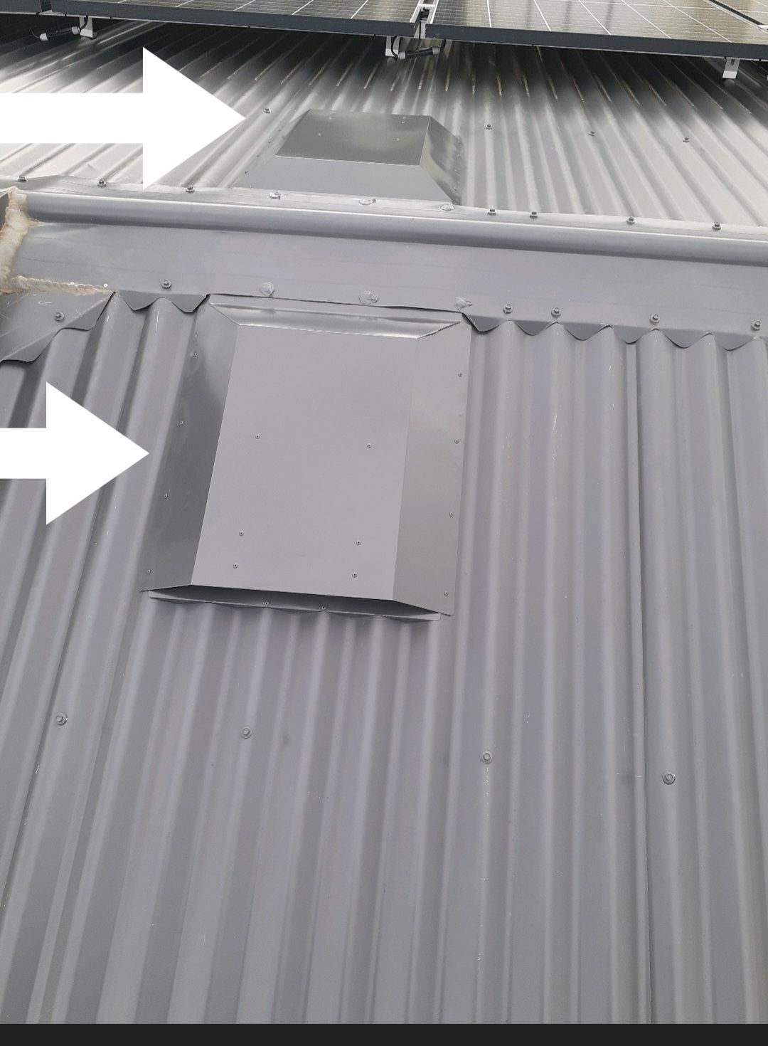 A Close Up of a Roof With Two Arrows Pointing in Opposite Directions — Vent Wise in Twin Waters, QLD