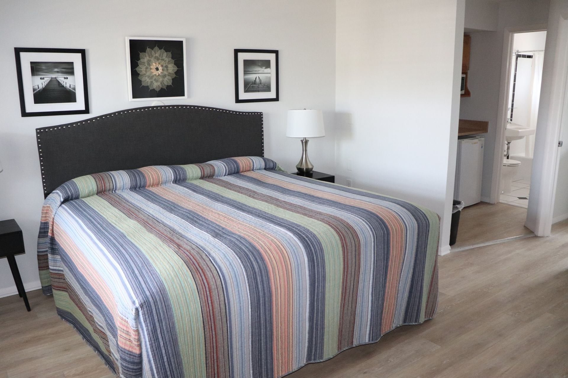 A bed with a striped blanket in a hotel room