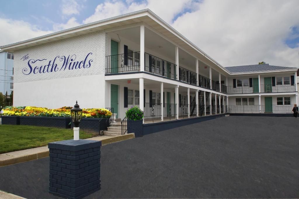 A large white building with a sign that says heritage inn on it.