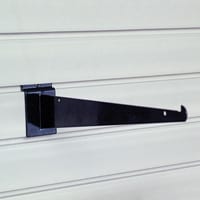 A black shelf bracket is attached to a white wall.