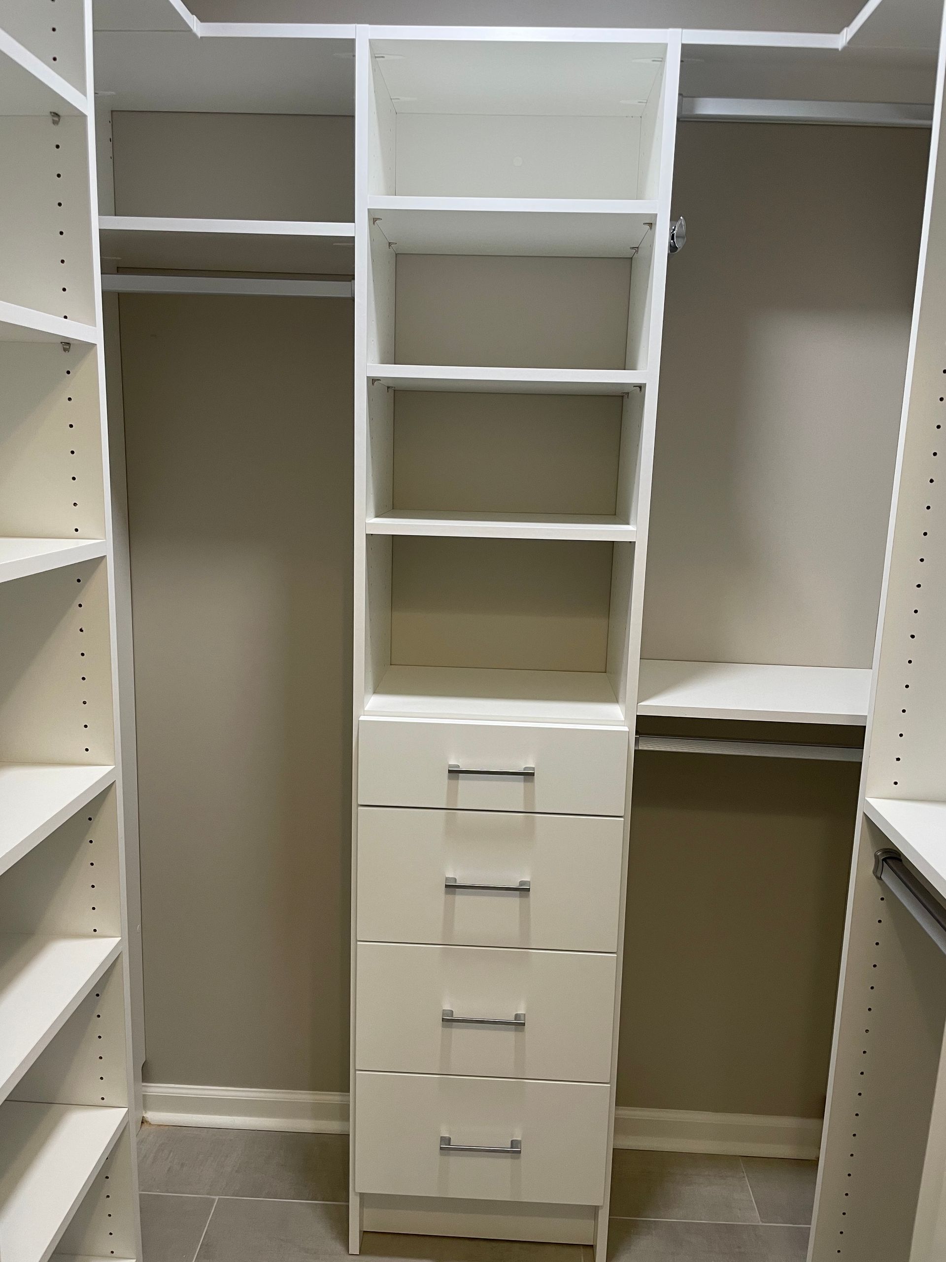 White closet organizer with shelves and drawers.