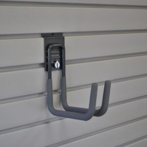 A gray hook is hanging on a white wall.