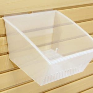 A clear plastic basket is hanging on a wooden wall.