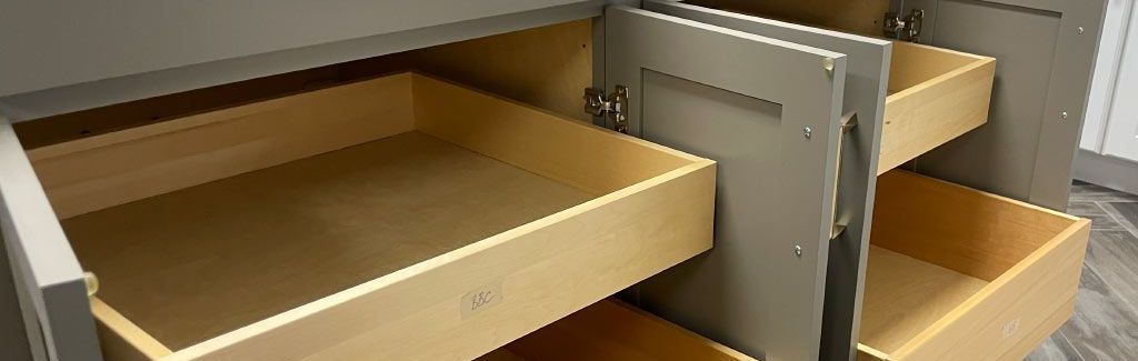 A close up of a cabinet with drawers and a door open.