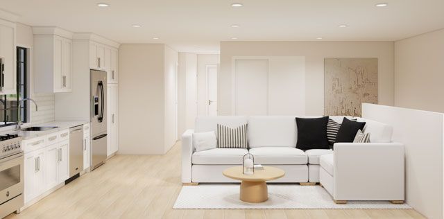 Bright modern white living room with sectional sofa, coffee table, and open kitchen