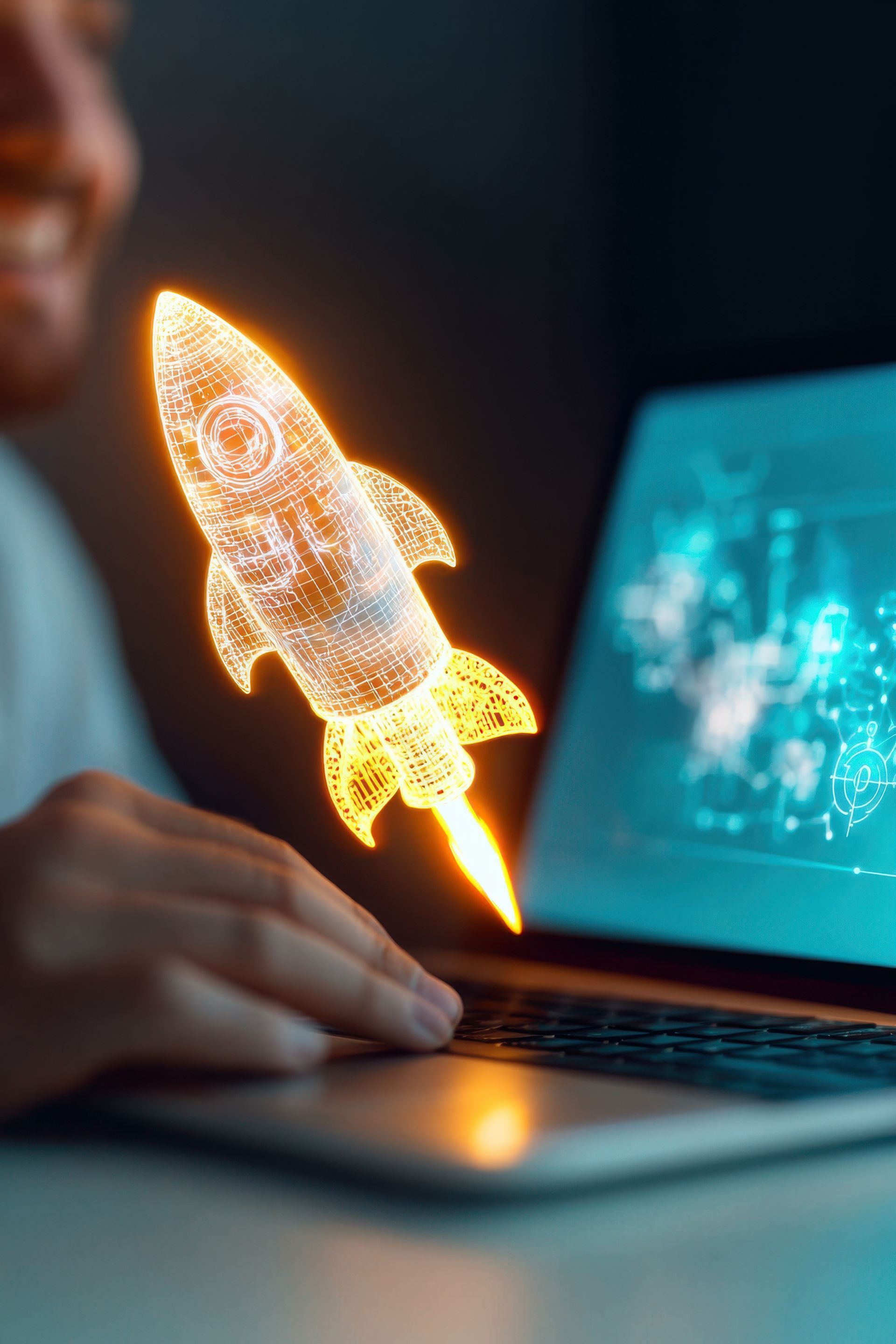 Person smiling, using laptop with a glowing rocket graphic overlay.