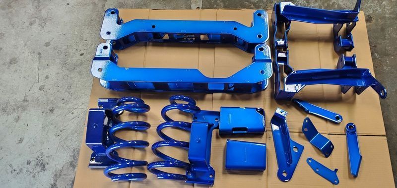 A Bunch of Blue Parts Are on a Cardboard Box