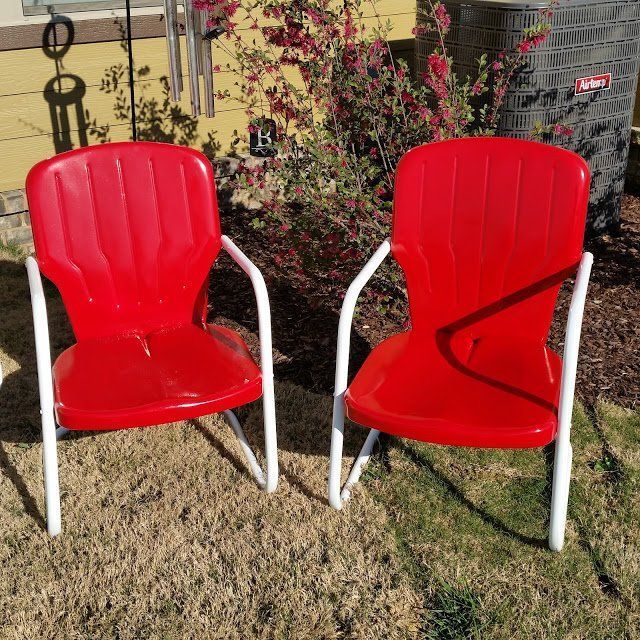 Two Red Chairs Are Sitting Next to Each Other in the Grass