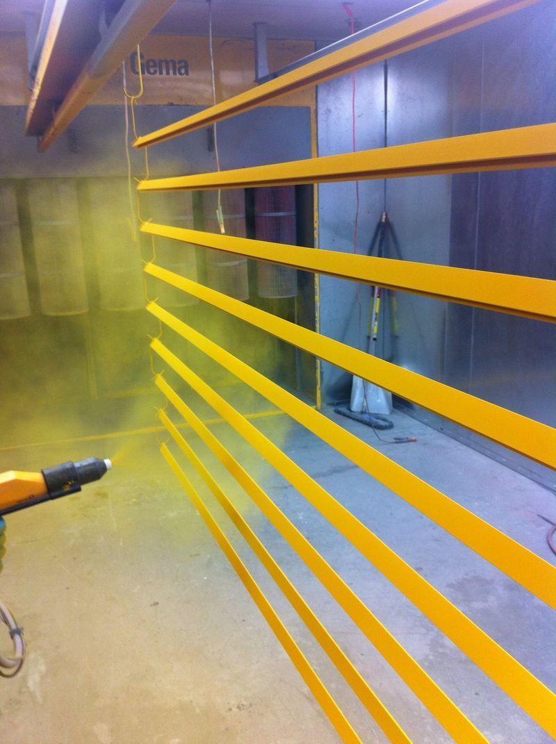 A Machine is Spraying Yellow Paint on a Wall