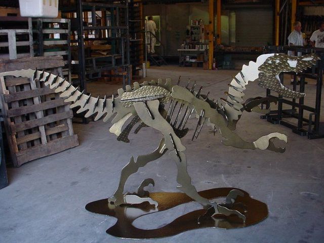 A Skeleton of a Dinosaur is on Display in a Warehouse