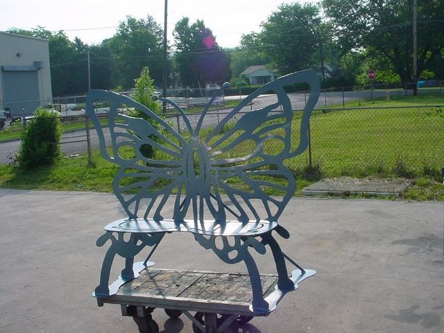 A Blue Bench With a Butterfly Design on It