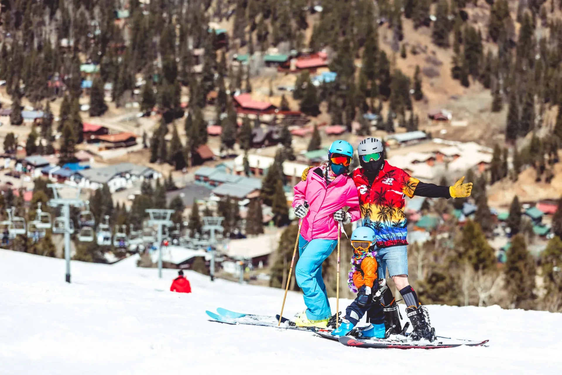 A group of people are skiing down a snow covered slope.