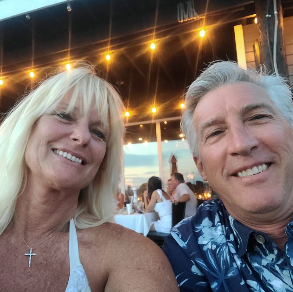 A man and a woman are smiling for a picture
