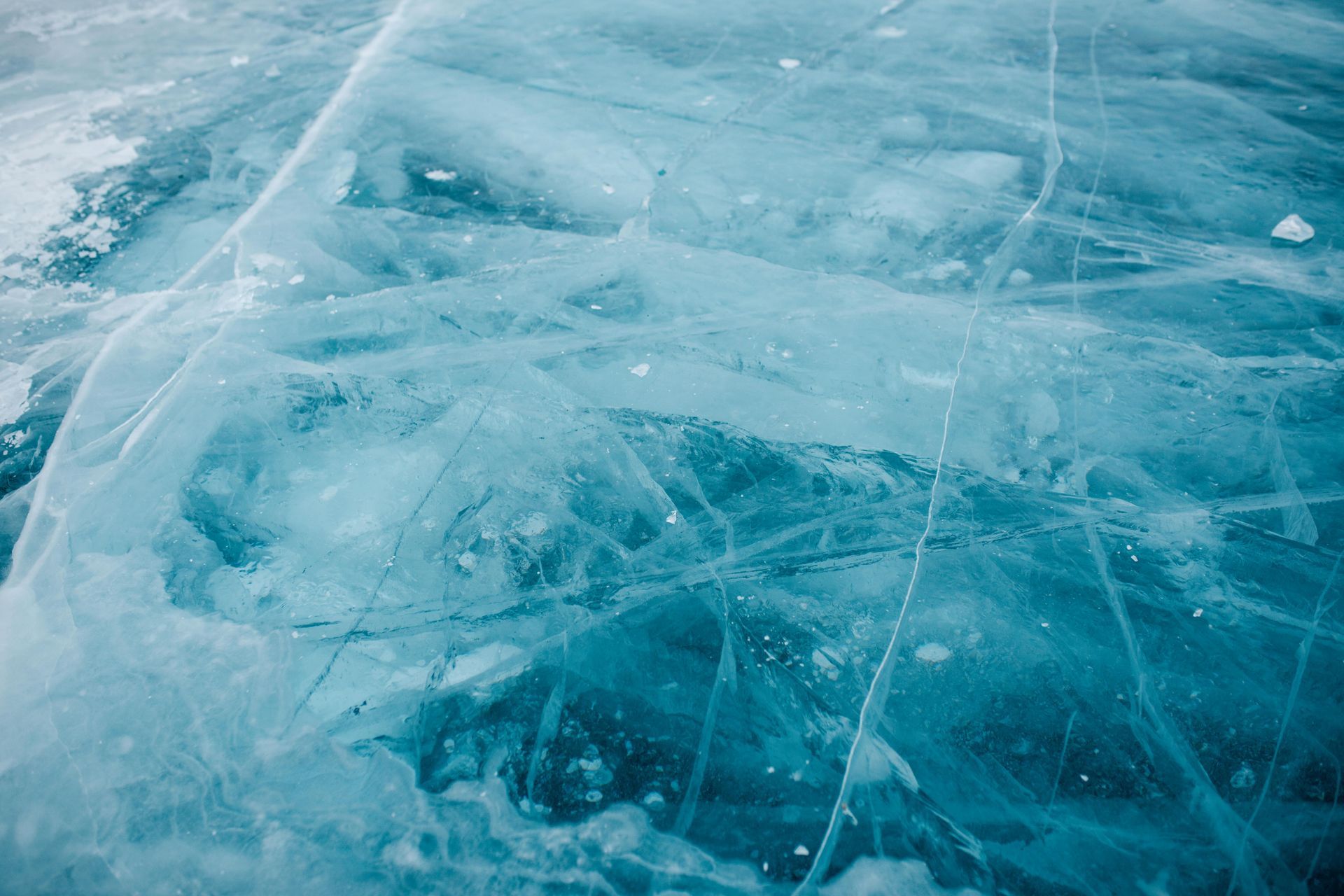 Translucent blue ice with cracks and bubbles.
