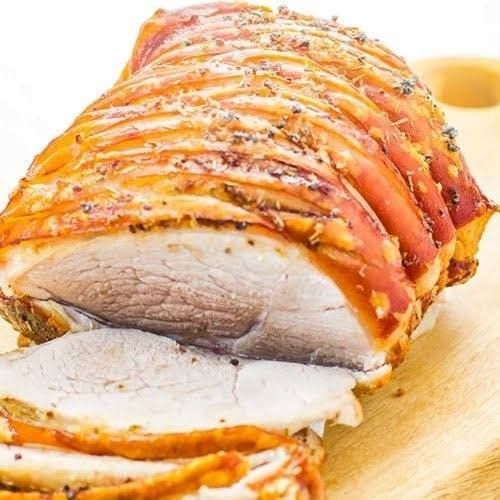 Roasted Pork Loin With Crispy Skin On Wooden Board — Mels Catering in Garbutt, QLD
