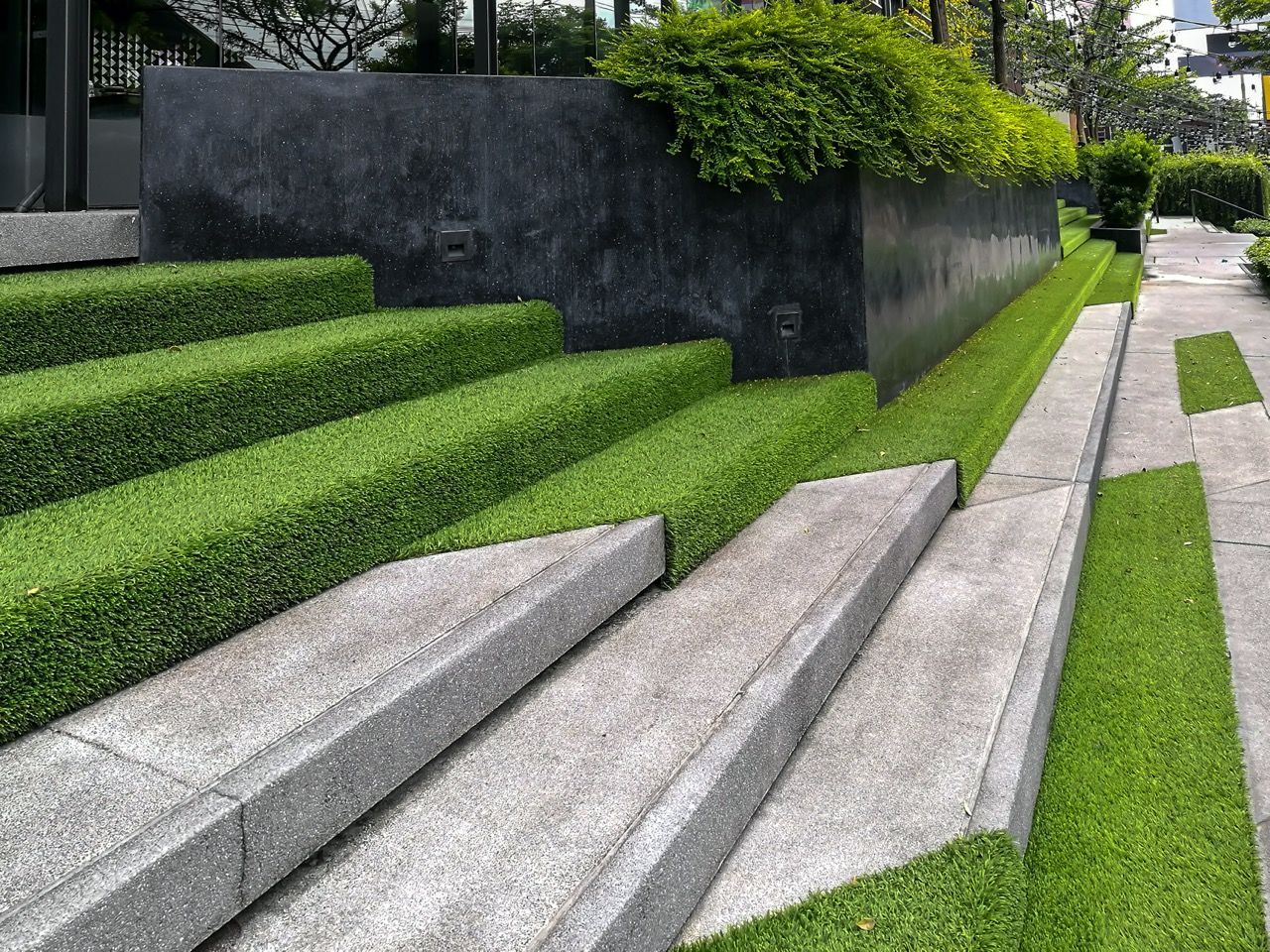 A set of stairs surrounded by grass and bushes.
