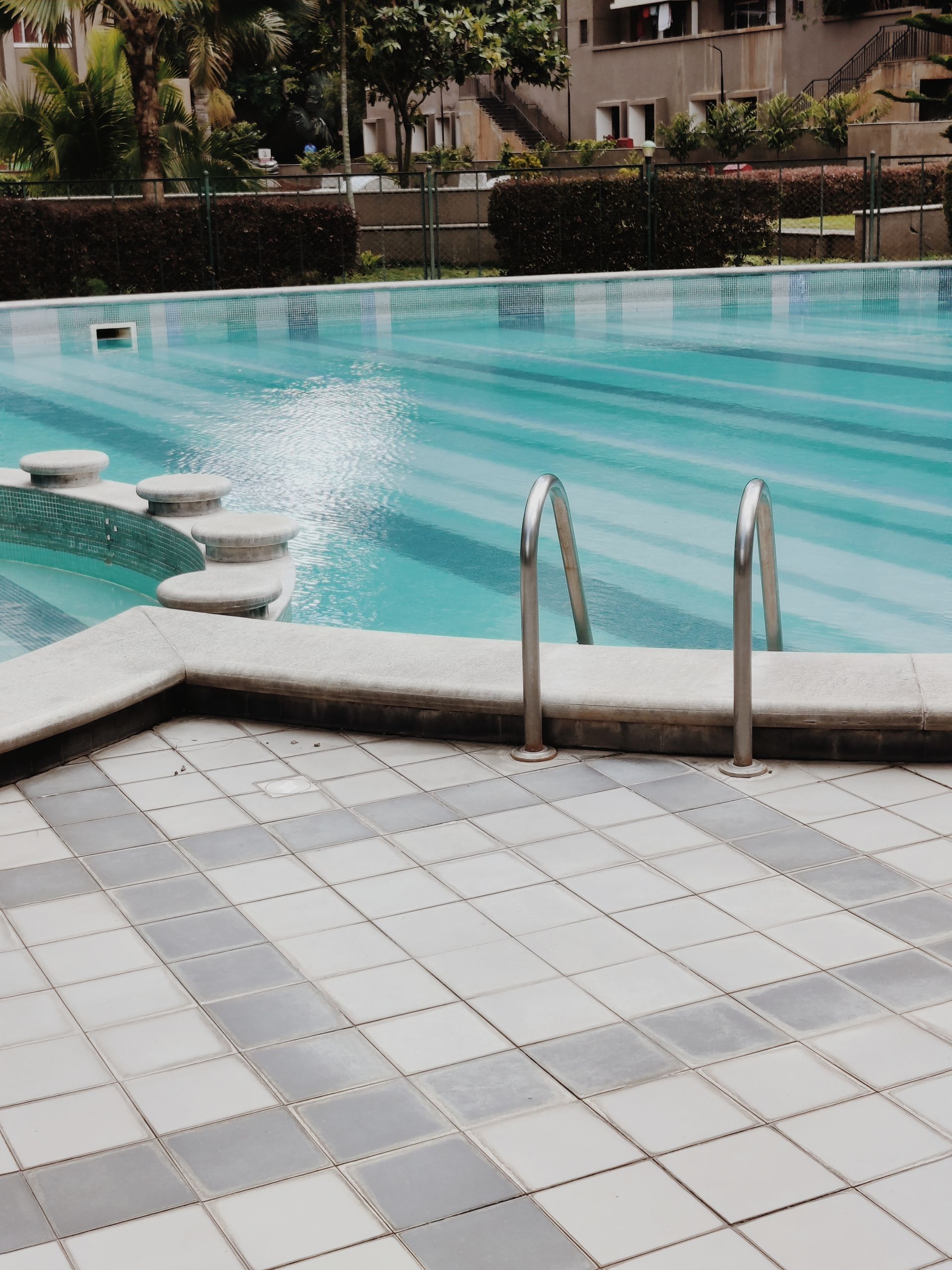 A large swimming pool with stairs leading to it