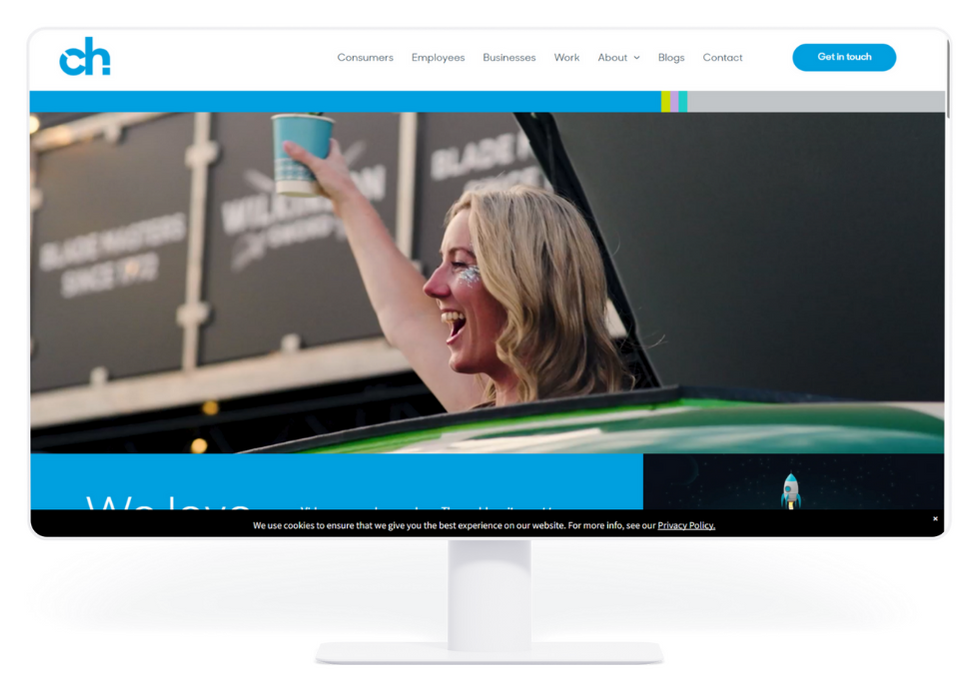 Website homepage featuring a person raising a can, smiling in front of a dark background with text.